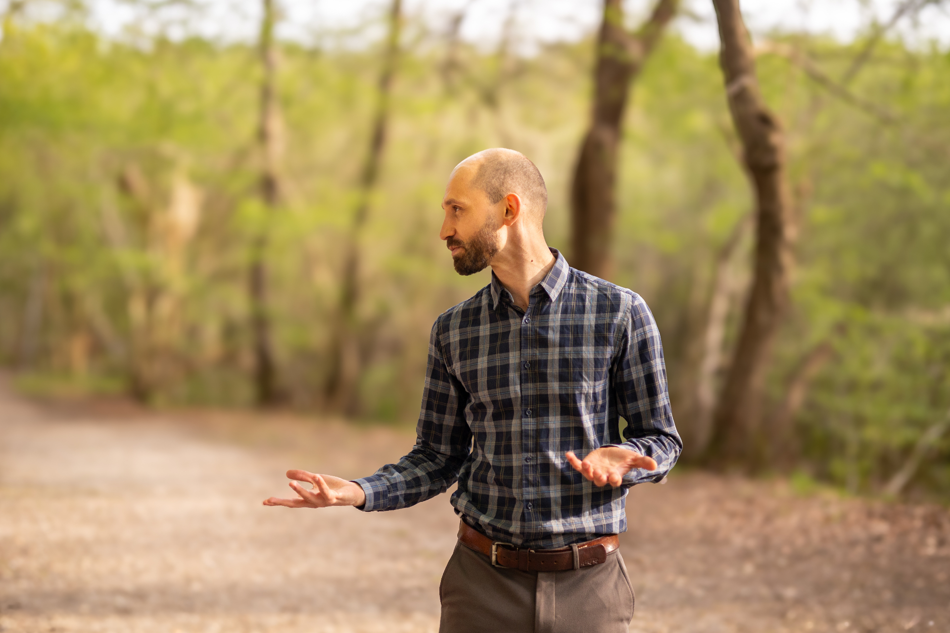 Jan gesturing thoughtfully in a forest